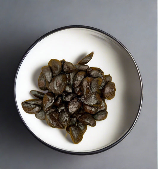 Bowl of peeled black garlic